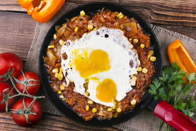 Fried eggs with mexican food in a pan