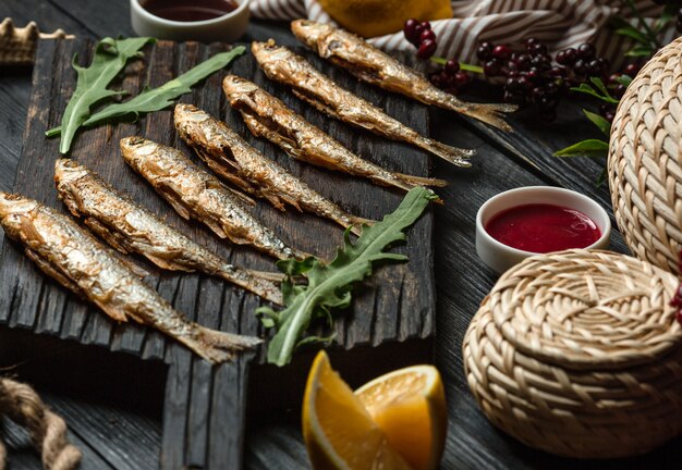 Fried fish set on wooden board