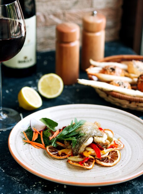 Fried fish with carrot and lemon slices