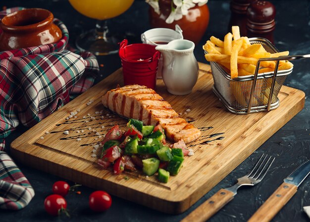 Fried fish with fresh salad and fries