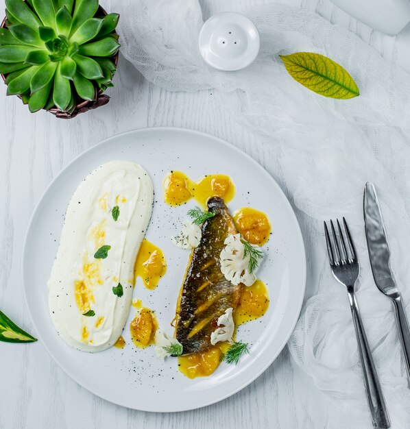 fried fish with sauce in the plate