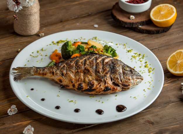 fried fish with vegetables in the plate 3