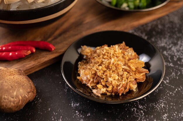 Fried Garlic on Black Plate with Chili and Shiitake.