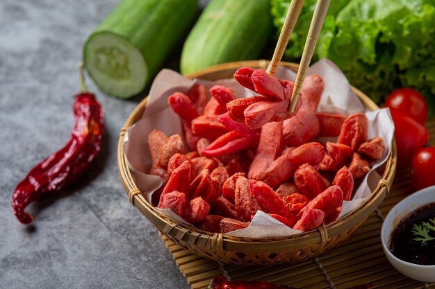 Fried hot dog or sausages on the dark surface.