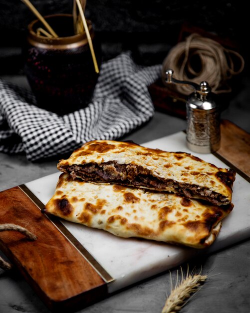 Free photo fried meat in fried bread on a wooden board