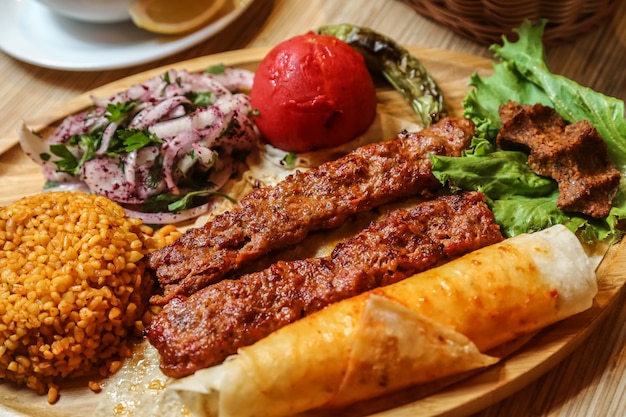 Fried meat lula with sliced onion with herbs and bread