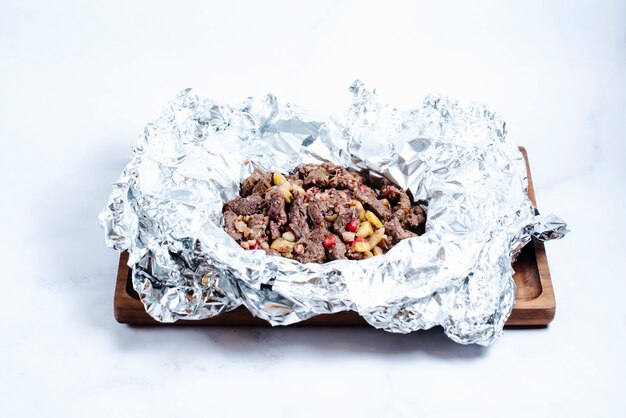 fried meat pieces with pomegranate