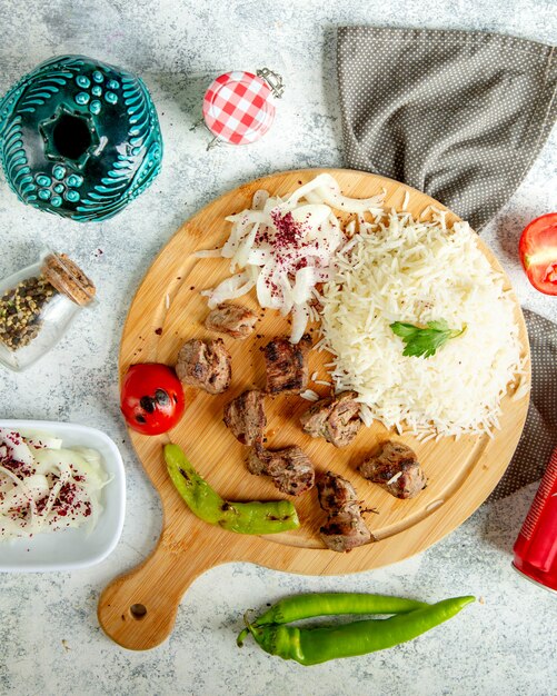 Fried meat pieces with sliced onion and rice