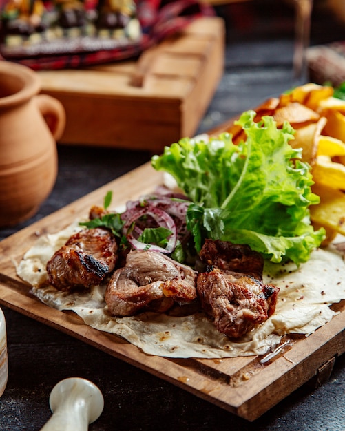 Fried meat and potatoes with herbs