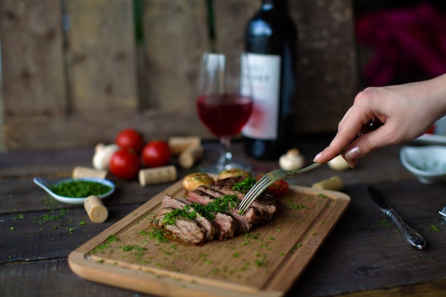 Fried meat and potatoes on wooden board