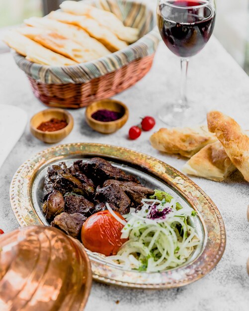 Fried meat served with onion and tomato