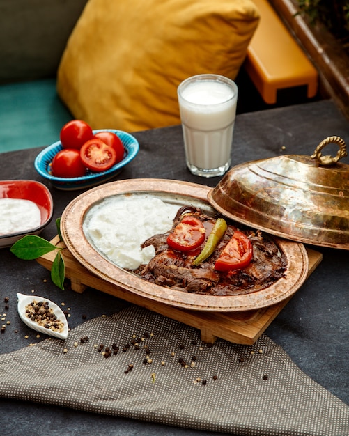 Fried meat slices and sour cream with side ayran and tomatoes