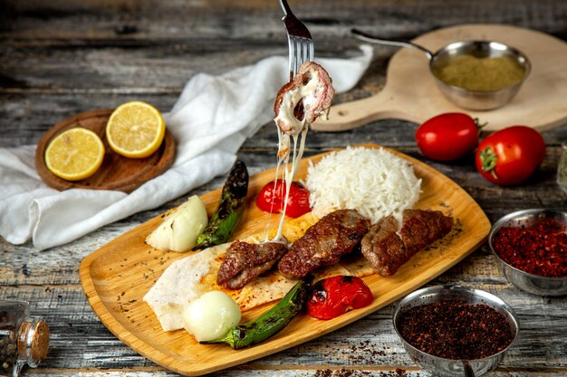 fried meat with cheese rice tomato pepper side view