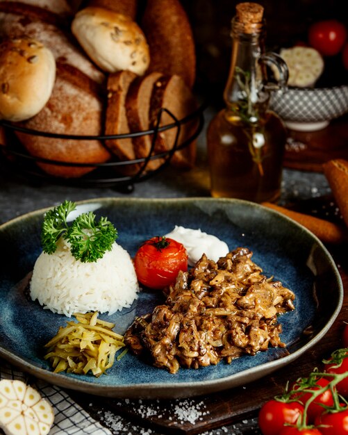 Fried meat with mushrooms and rice