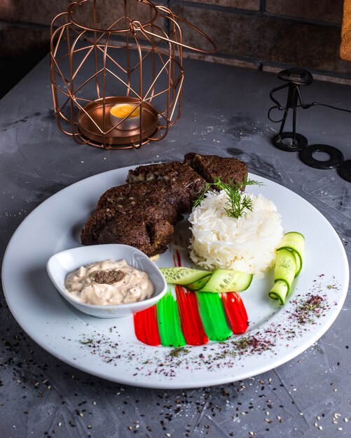 Fried meat with rice on the table