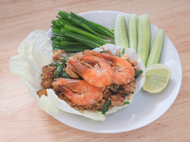 Fried noodle Thai style with prawns and fresh vegetable called 