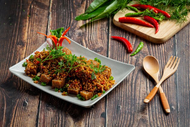 Fried Pork with Dried Chili and Salt on dark background