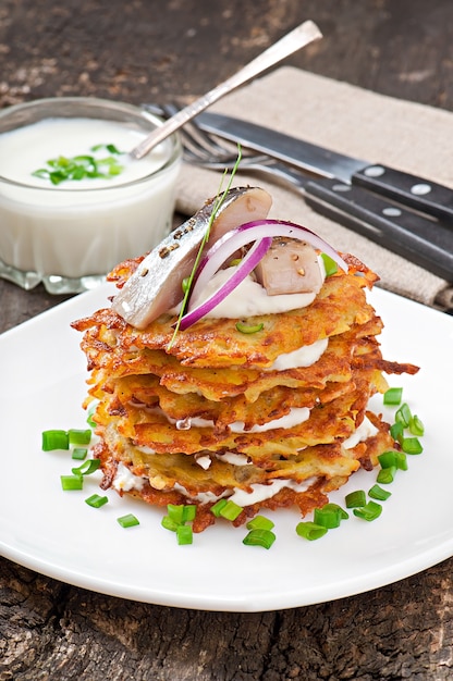 Fried potato pancakes  with herring 