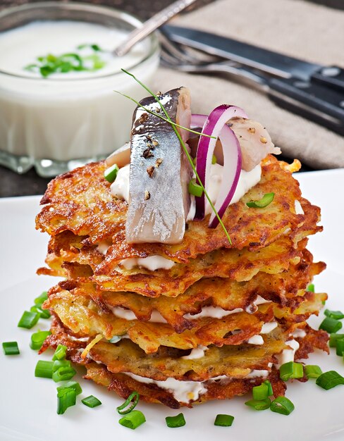 Fried potato pancakes  with herring 