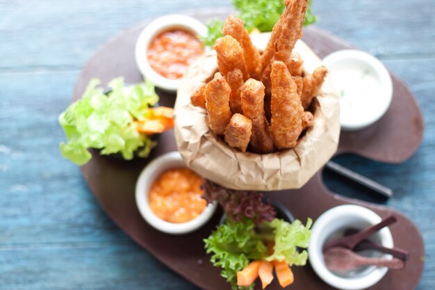 Fried potato with dips on design plate