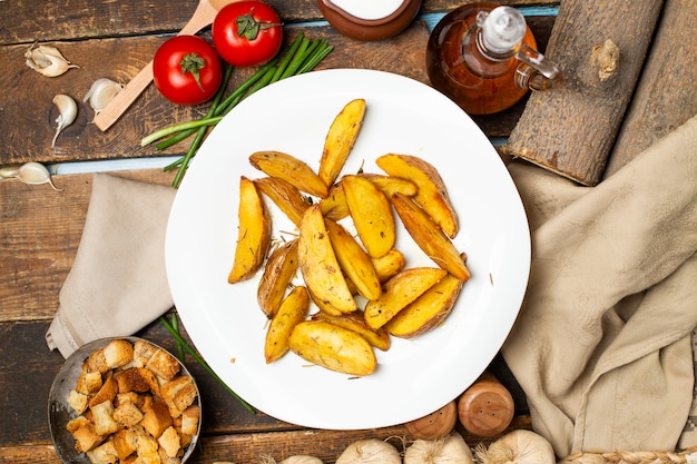 Fried potato with herbs and yogurt in white plate.