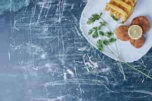 Free photo fried potatoes with cotlets and lemon.