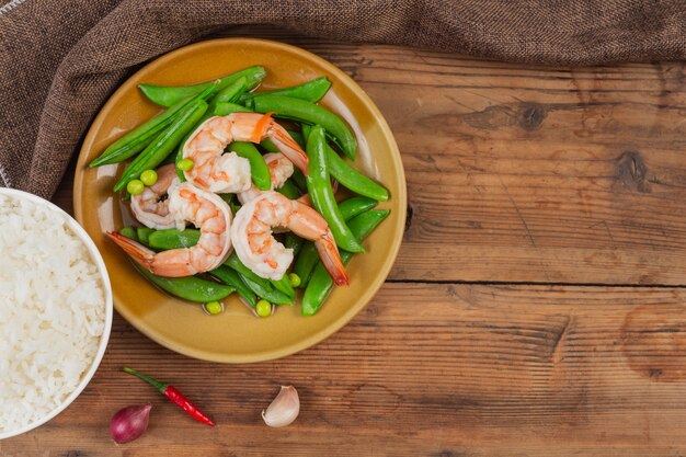 Fried prawns with fried peas and green peas.