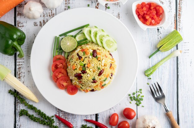 Fried rice in a plate on a white wooden floor.