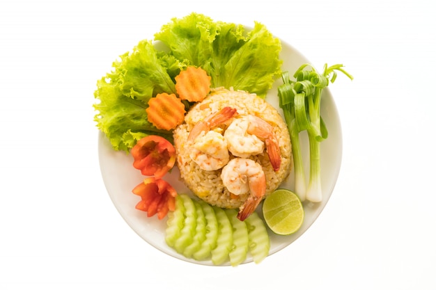 Fried rice with shrimp and prawn on top in white plate