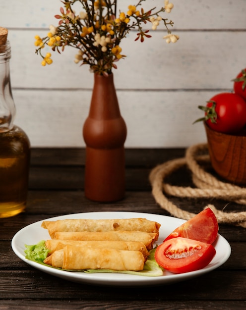 Free photo fried rolls in pita bread on a wooden table