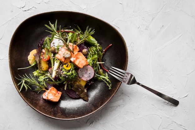 Fried salmon with herbs top view