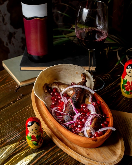 Fried sausages served with onion and pomegranate