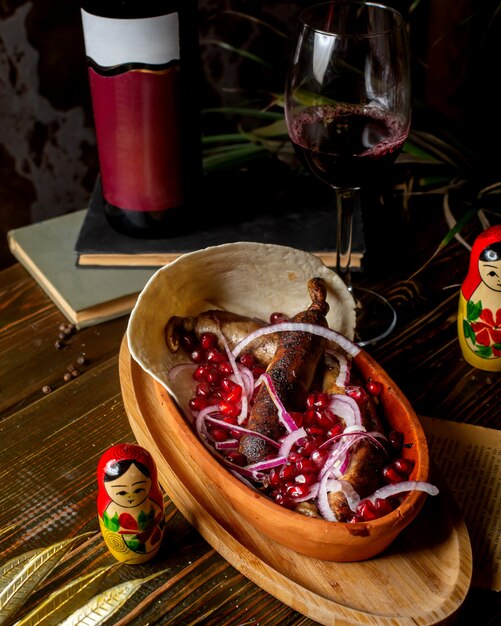 Fried sausages served with onion and pomegranate