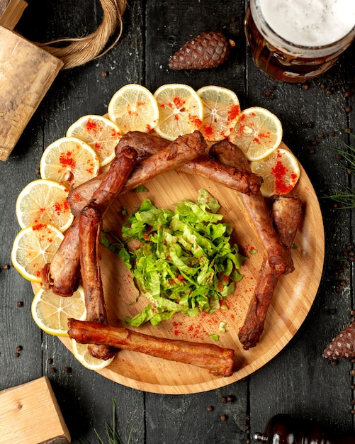 Fried sausages with sliced lemon and pepper