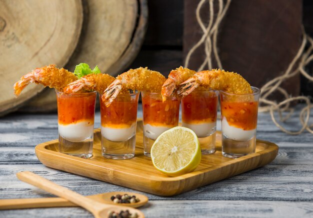fried shrimp cocktail shots filled with mayonnaise and sweet chili sauce