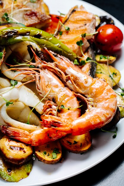 fried shrimps and oysters with vegetable salad and herbs