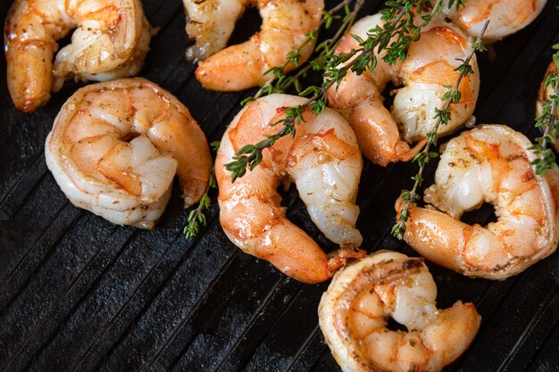 Fried shrimps with herbs, close up view.