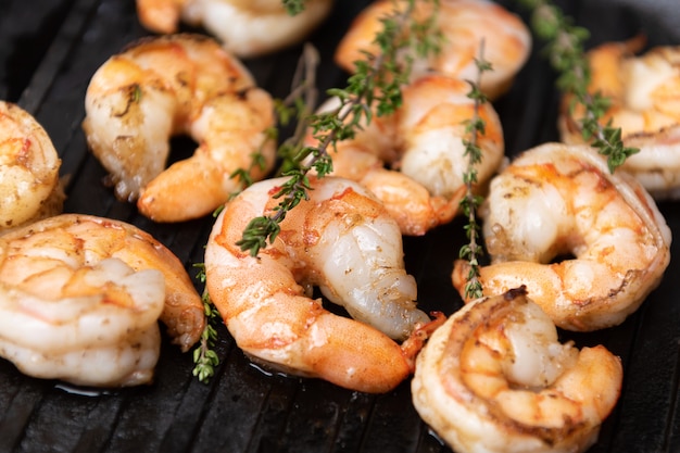 Fried shrimps with herbs, close up view.