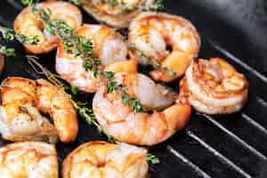 Free photo fried shrimps with herbs, close up view.