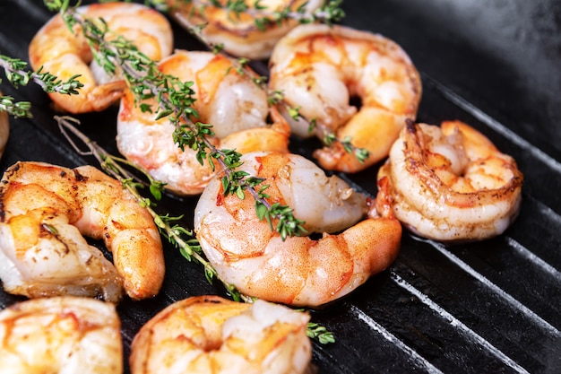 Fried shrimps with herbs, close up view.