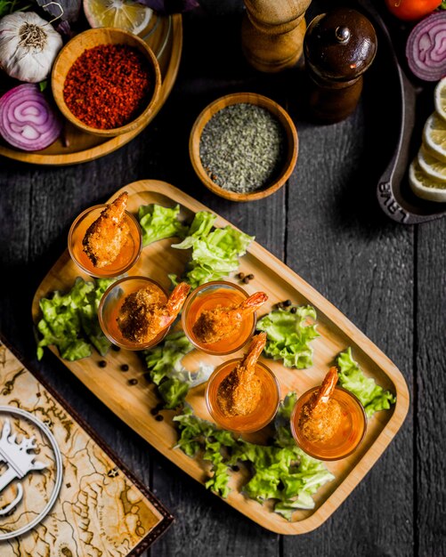 Fried shrimps with sauce on wooden board