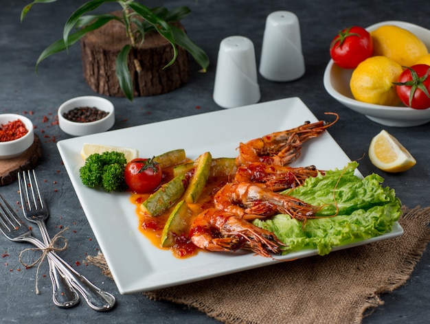 fried shrimps with vegetables on the table