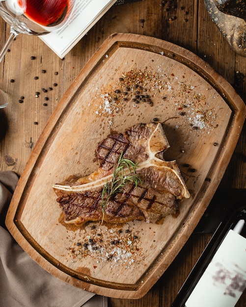 Fried steak on wooden board