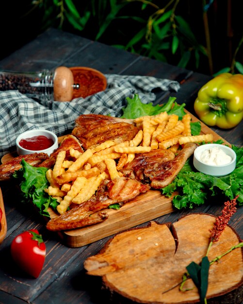 Fried tobacco with fries on a wooden board