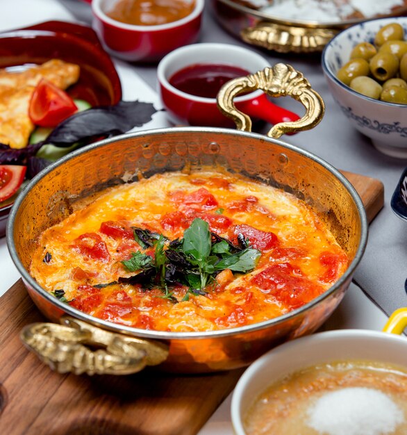 Fried tomatoes with eggs on the table