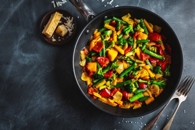 Fried vegetables with sauce on pan