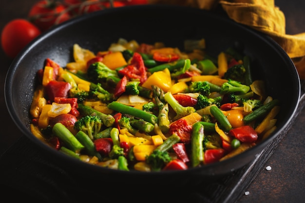 Fried vegetables with sauce on pan