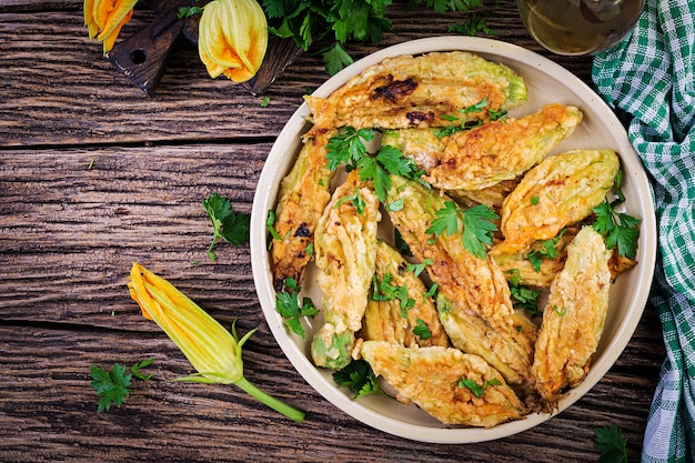 Fried zucchini flowers stuffed with ricotta and green herbs