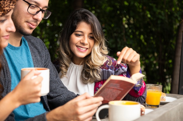 Friend reading a book together