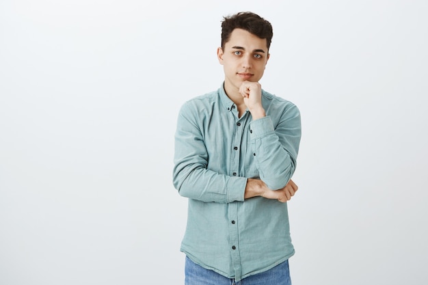 Free photo friendly attractive european male student in turquois shirt